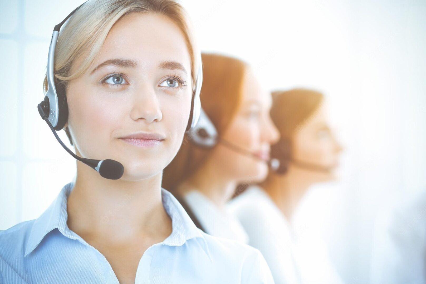 cheerful-smiling-business-woman-with-headphones-consulting-clients-group-diverse-phone-operators-work-sunny-office-call-center-business-people-concept_665183-6358